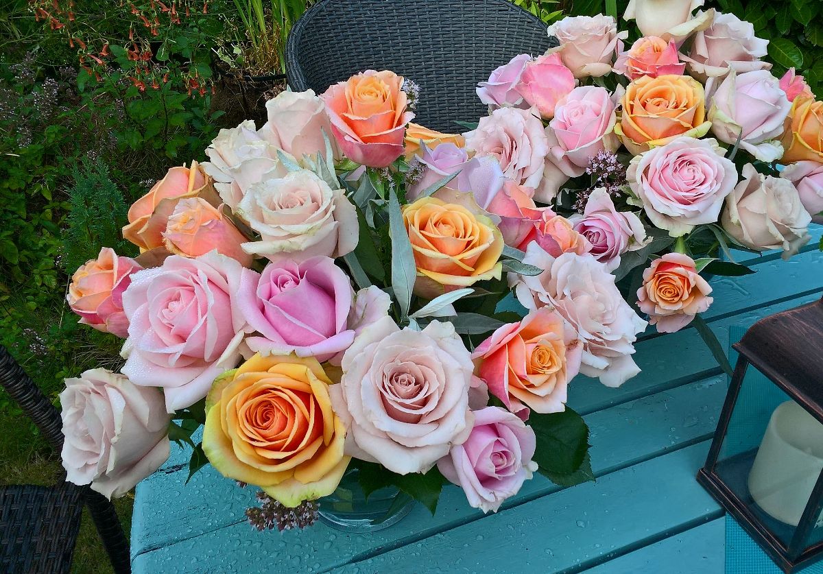 Table centres of mixed pastel scented roses. 