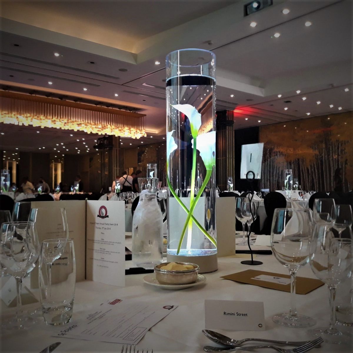 3 calla lily's submerged in water with LED White lighting illuminating the centrepiece perfectly