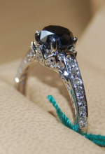 3.5 ct black diamond with 24 white diamonds on the shoulders and sides. set in white gold