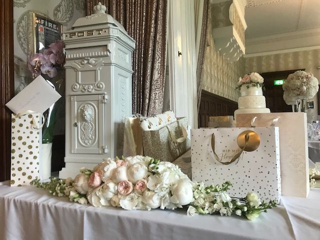 A table filled with kindly gifted presents along with a vintage post box to store all the best wishes for the happy couple.