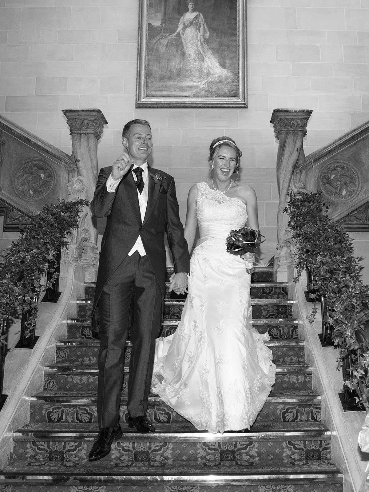 Bride and Groom coming down the beautiful staircase at Northcote House