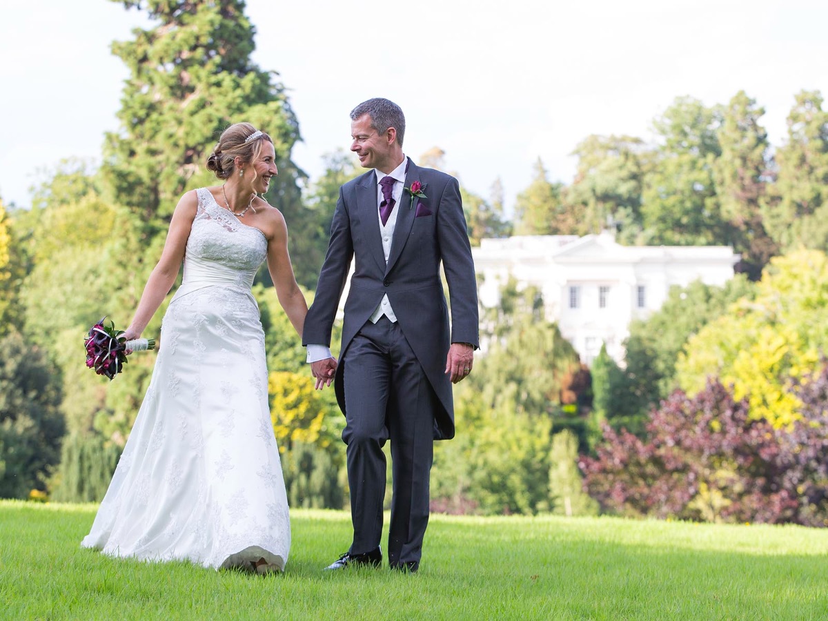 Bride and groom taking a little stroll in the grounds of Northcote House