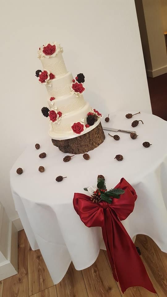 Wedding cake continuing the rustic theme, surrounded by real pine cones