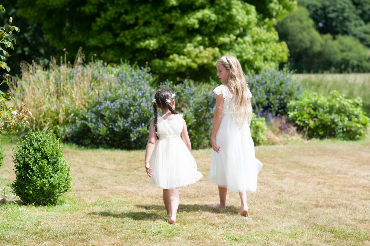 Beautiful flower girls in white - summer outdoor wedding venue
