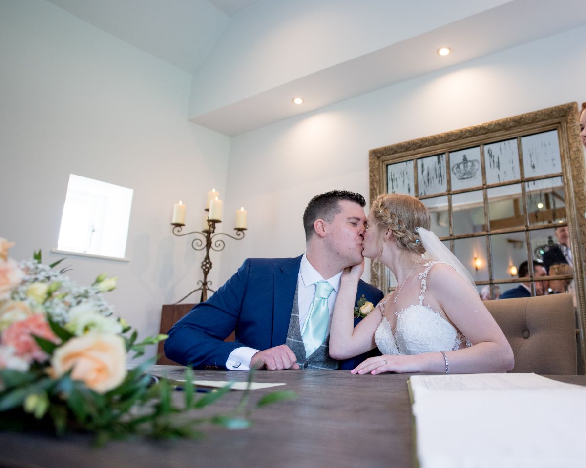 The kiss at the indoor ceremony at SOUTHEND BARNS