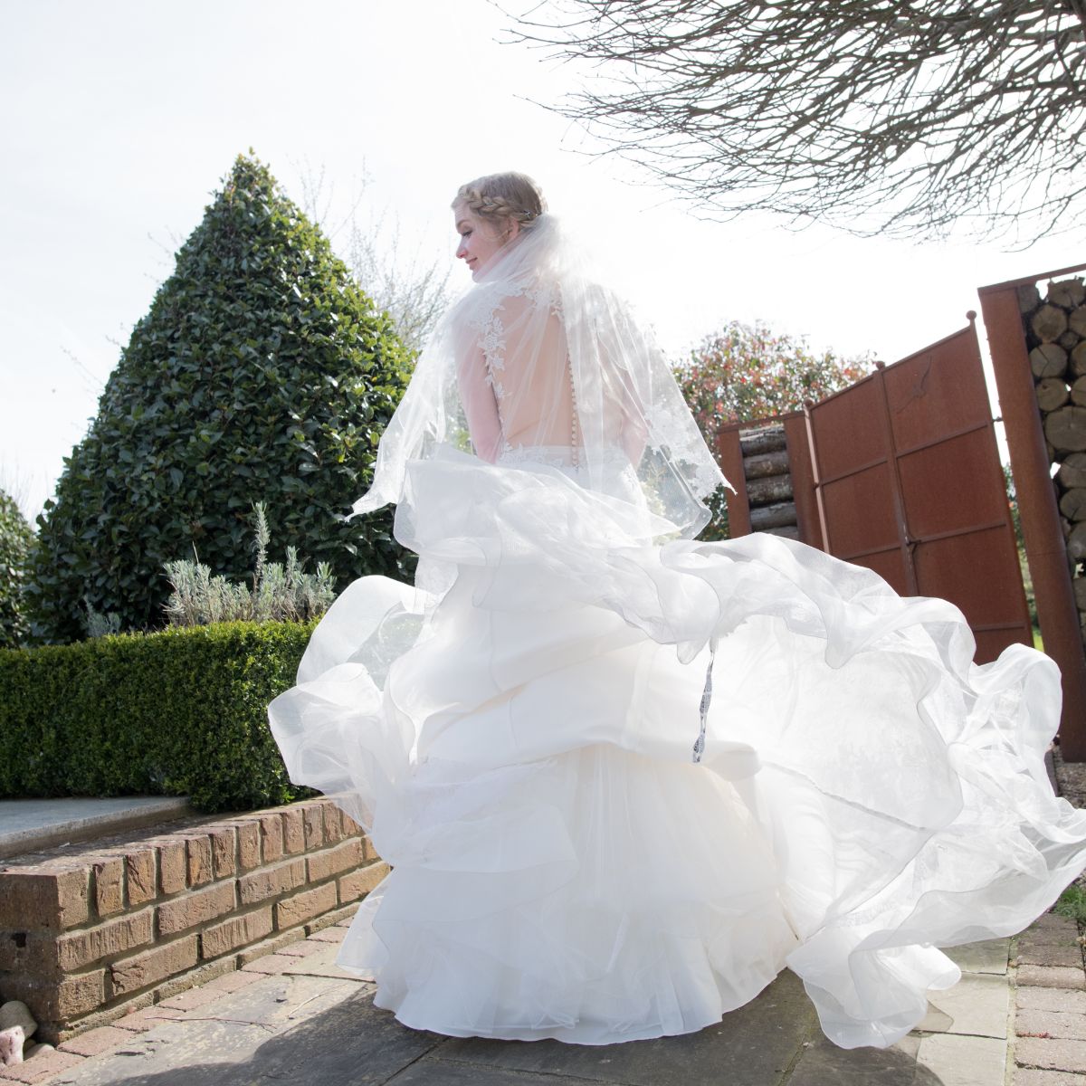 Bride spinning in the wind at SOUTHEND BARNS spring wedding