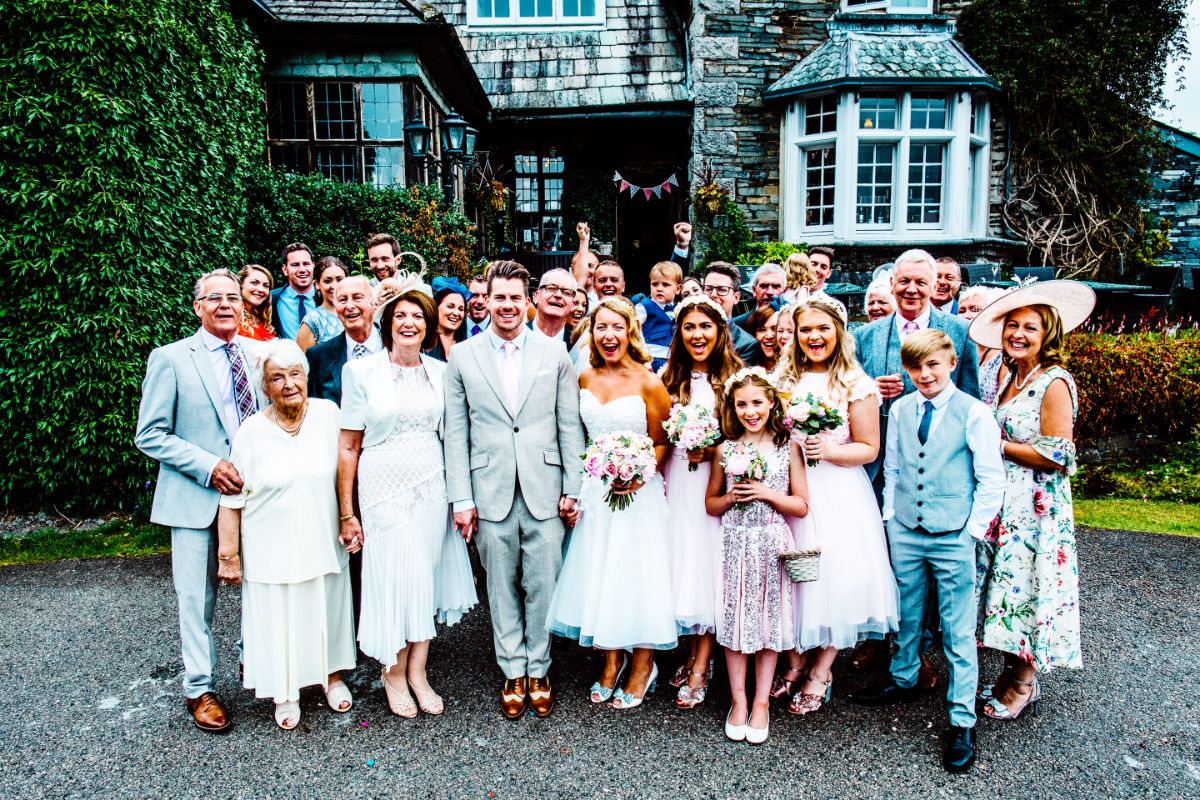 Rebecca and Gary with their wedding guests standing in front of Broadoaks Country House