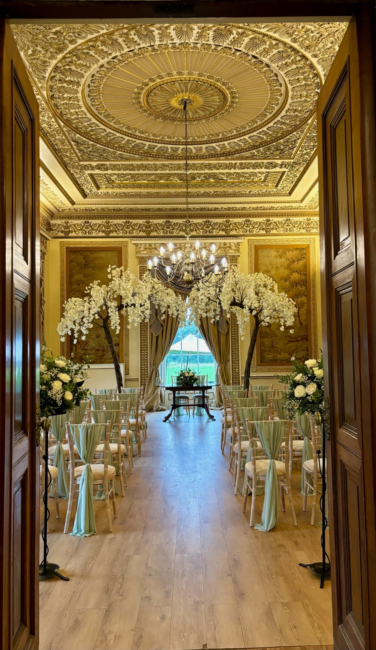 The stunning Tapestry Room for their beautiful ceremony, finished with blossom trees  