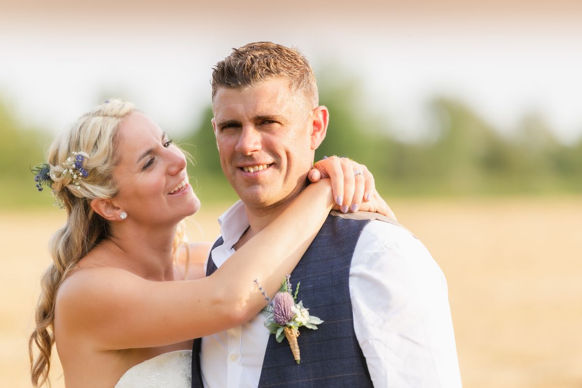 Bride and Groom in a wheat field as the sun starts to set.
