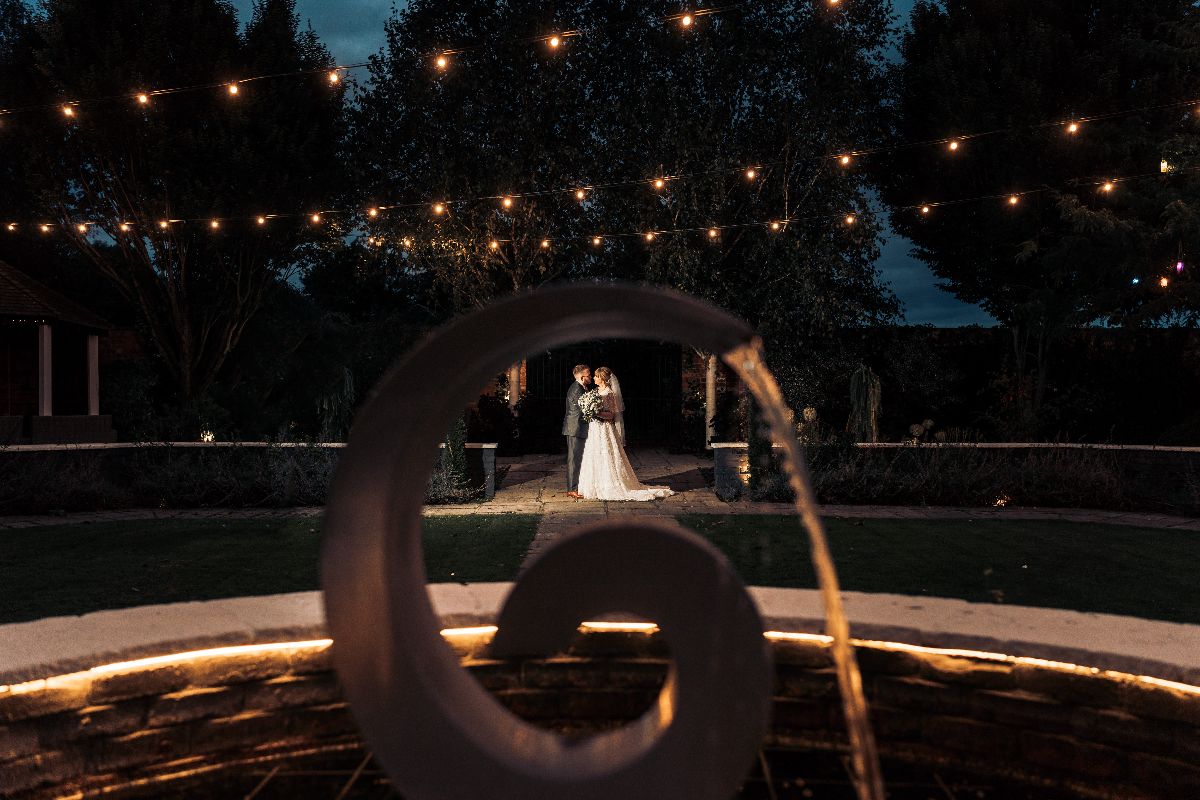 One of the bespoke fountains perfectly frame the happy couple at Jessica and Rhys wedding which was hosted at Lion Quays Resort in Shropshire.