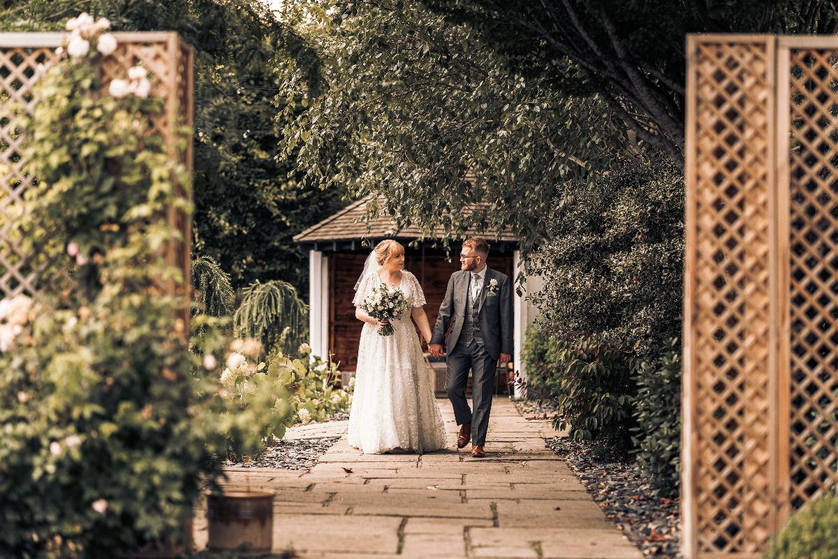 A moment to enjoy together on the long walk in the walled garden at Jessica and Rhys wedding which was hosted at Lion Quays Resort in Shropshire.