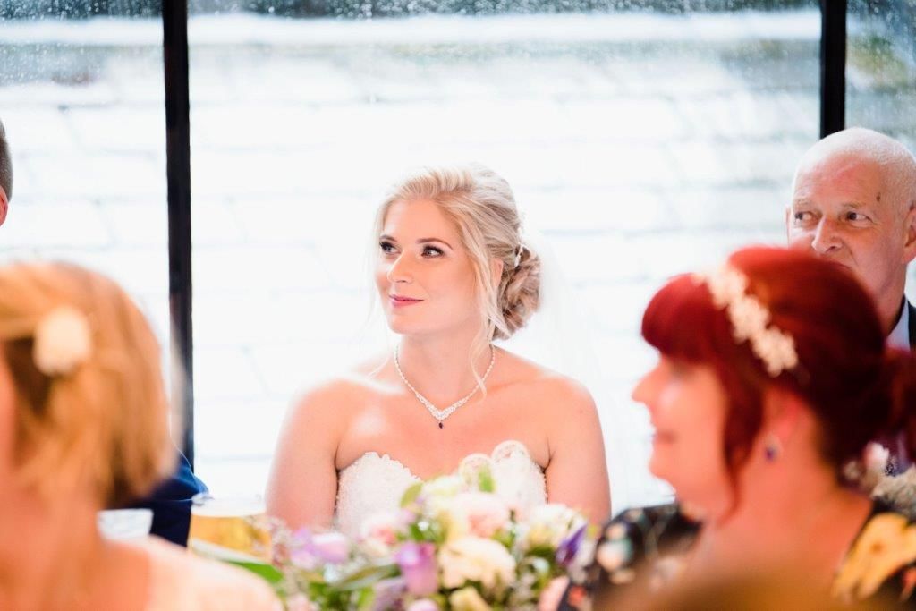 Beautiful bride, taking in the speeches of their special day