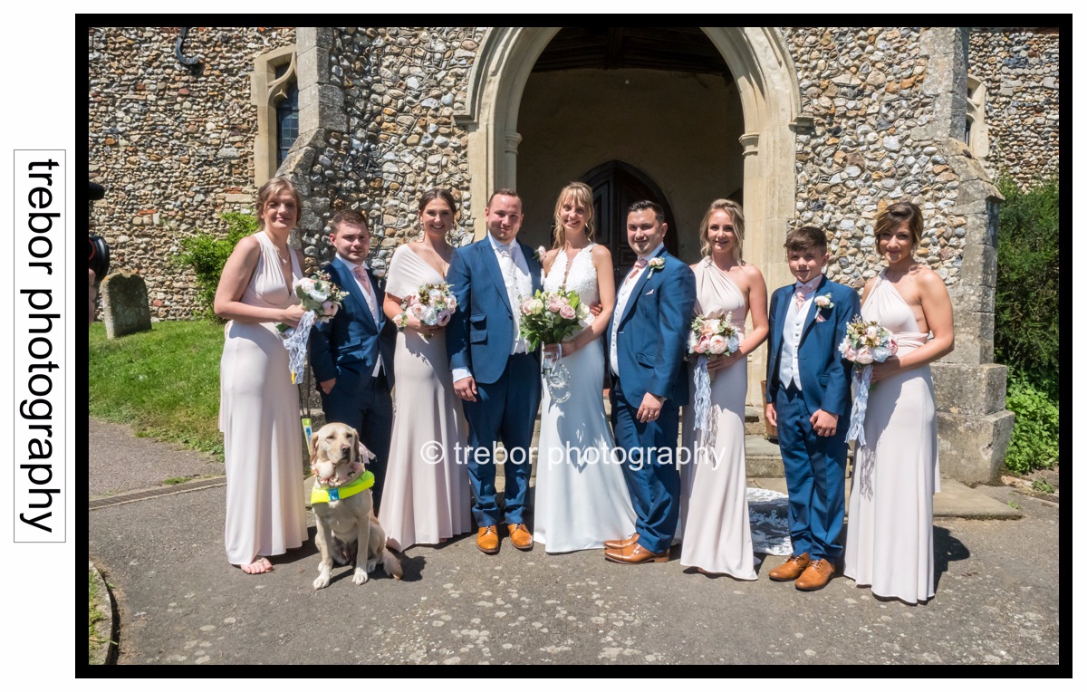 The Bride and Groom with their bridesmaids and groomsmen including the guide dog.