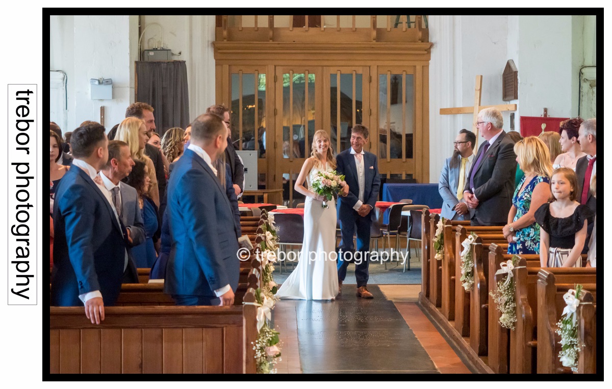 The bride and groom seeing each other for the first time in Church.