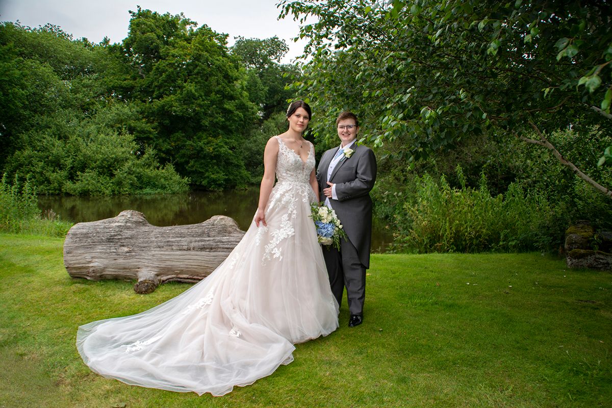 Bridal couple next to pond