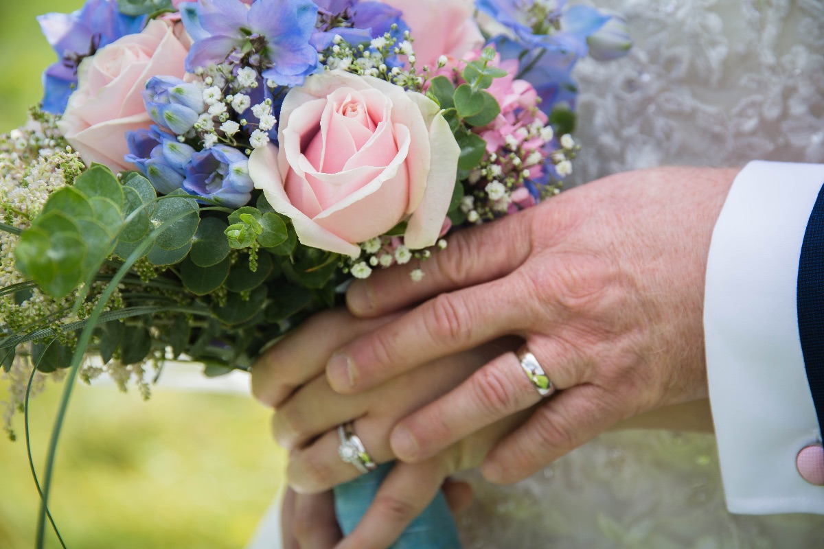 Love is in the details - beautiful bridal bouquet showing off the newly-weds new wedding rings!