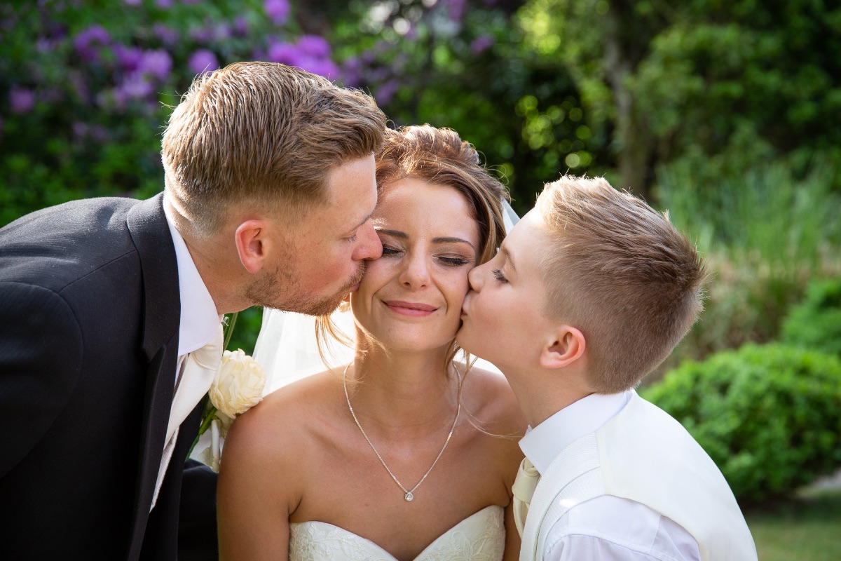 Bride kiss with groom & ring bearer