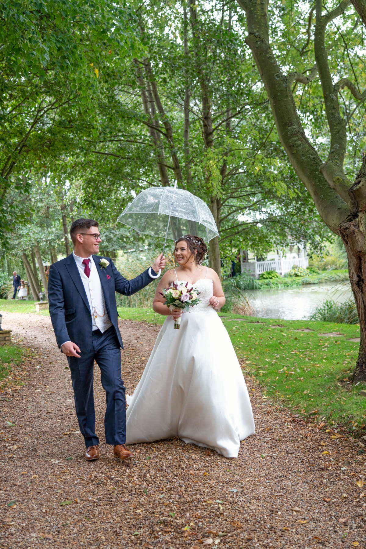 Chivalry is not dead! Glen keeps his bride dry after the ceremony