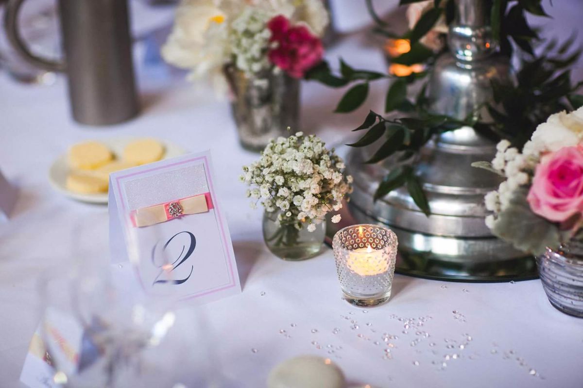 We had floral candlesticks with votives and little pots of flowers dotted around the base.. worked really well together..