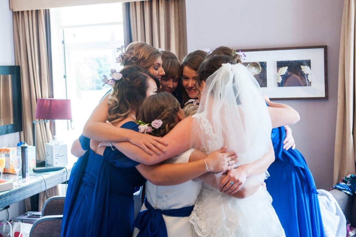 Girls group hug... Mother of the Bride is in the middle. 