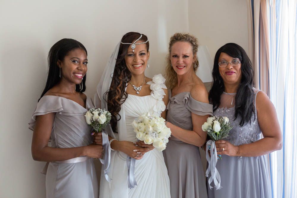 Bridesmaids wear pastel grey to fit the colour scheme