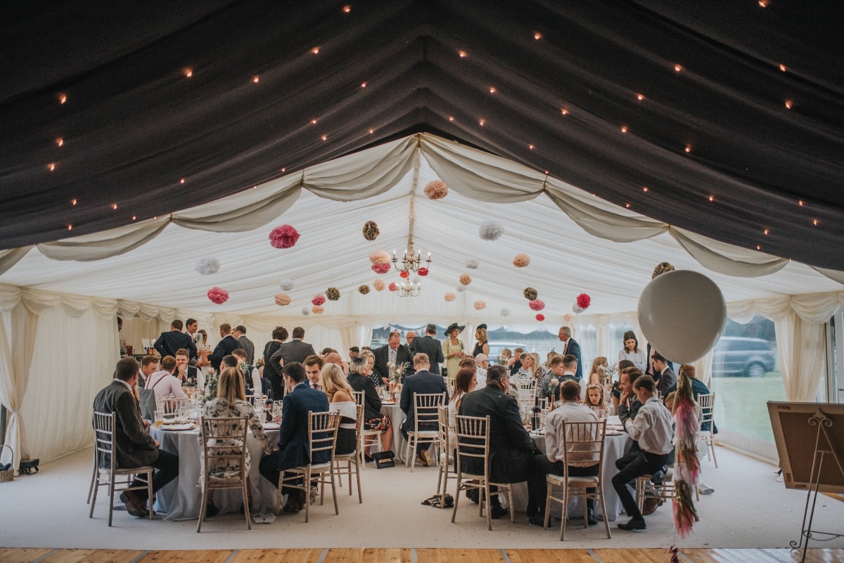 A marquee from Olympus Marquees filled with friends and family