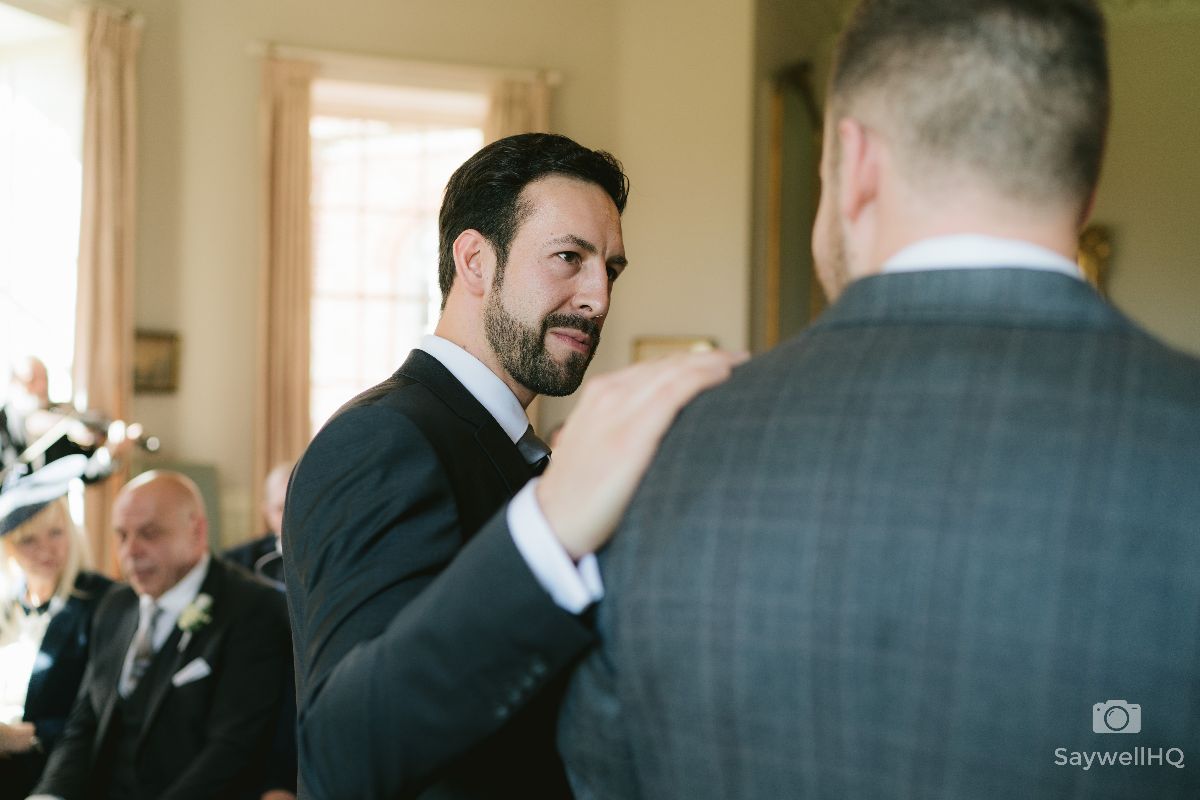 Norwood Park Wedding Photography - Brother giving the groom a reassuring hand on the shoulder