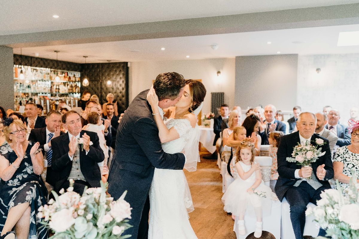 Chequers Inn Wedding Photography - Bride and Groom first kiss