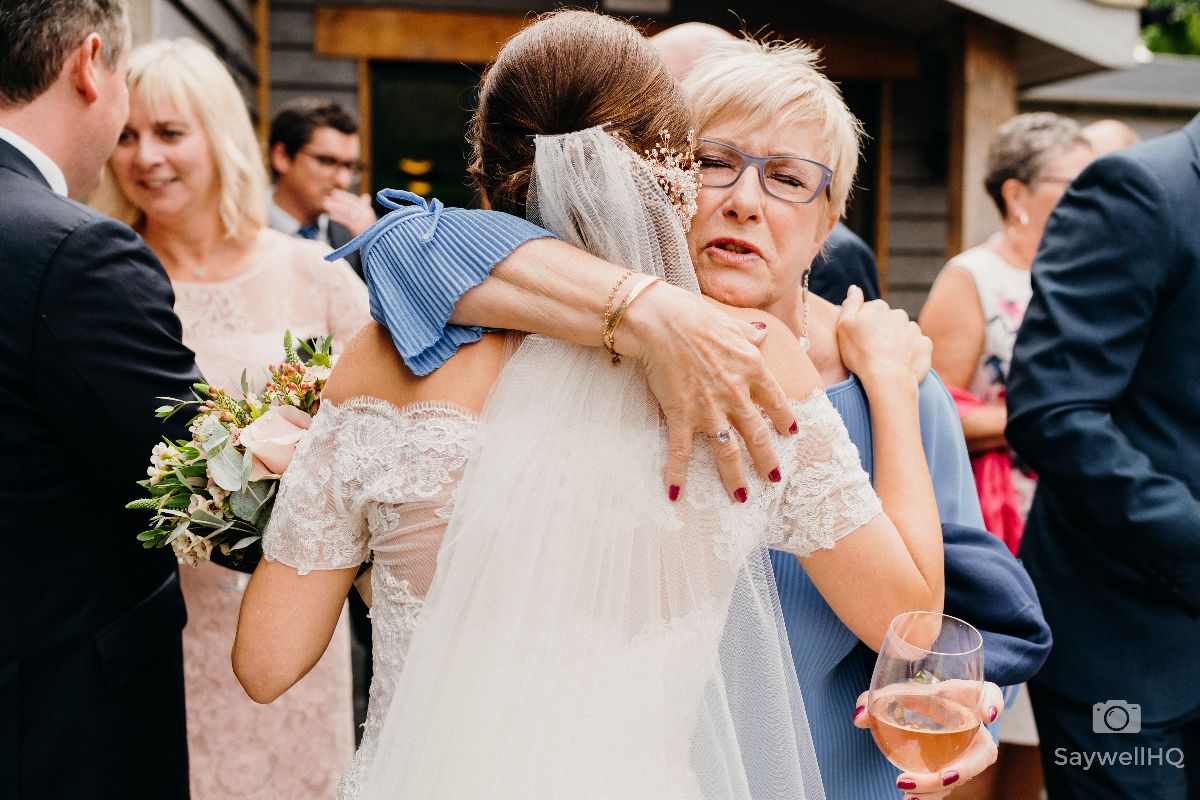Chequers Inn Wedding Photography - Emotional guest hugs