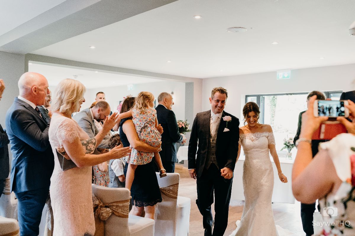 Chequers Inn Wedding Photography - Bride and Groom walking down the aisle as the new Mr and Mrs