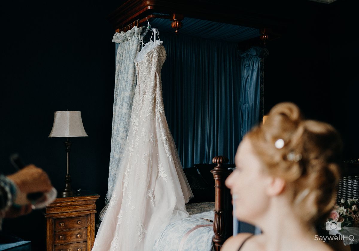 Prestwold Hall Wedding Photography - Bride looking at her wedding dress