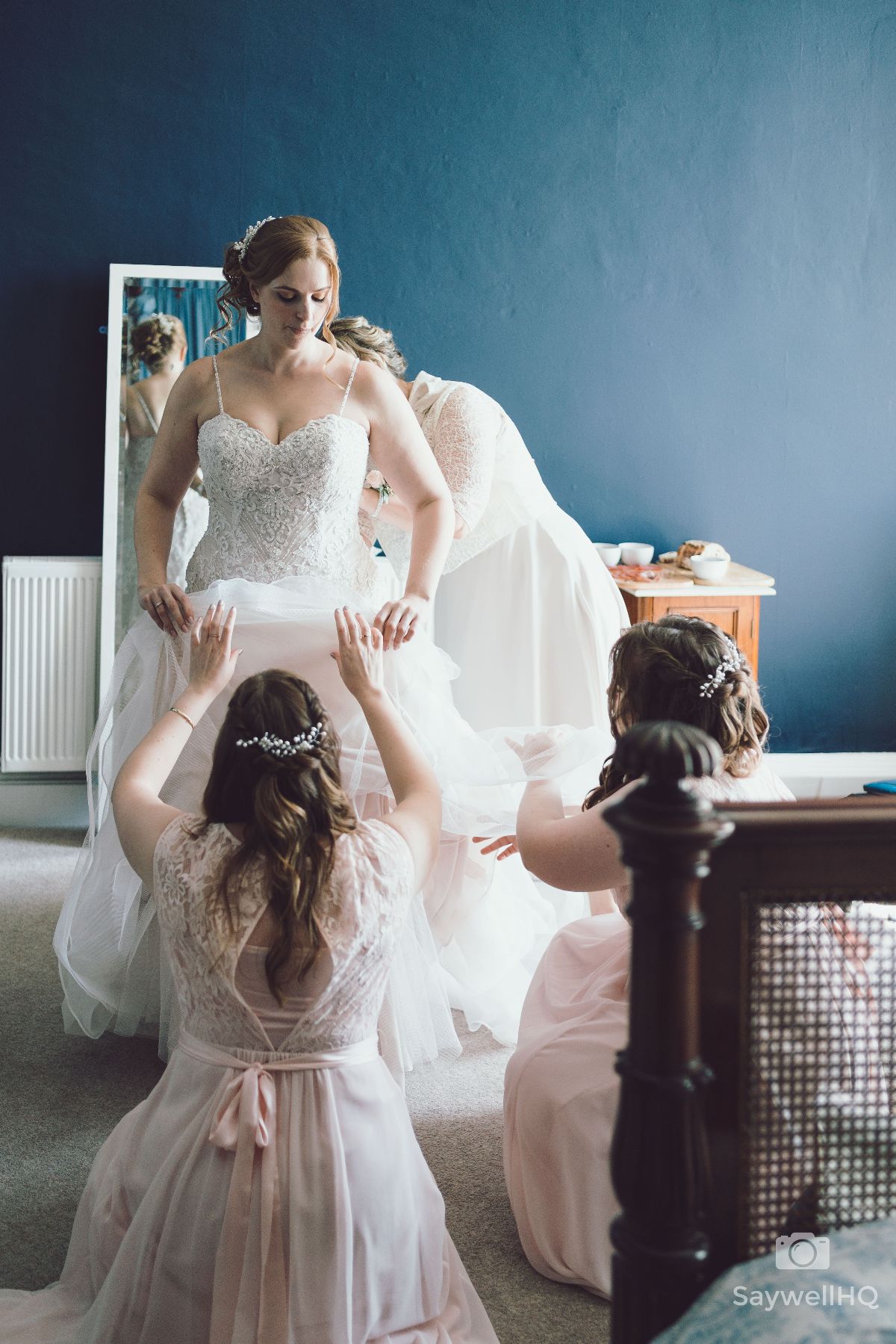 Prestwold Hall Wedding Photography - Bride and the final adjustments to her wedding dress
