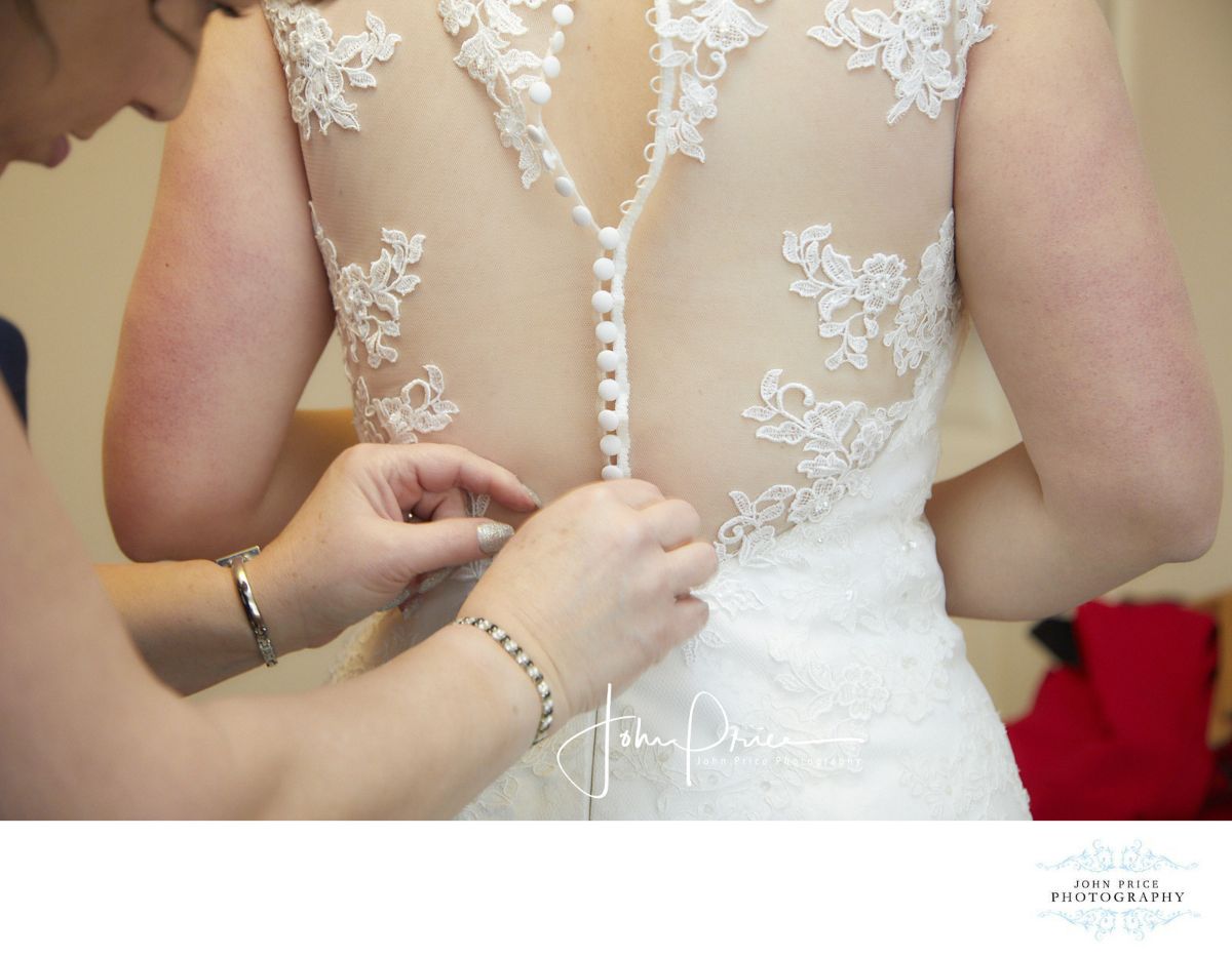 Mother helping Lyndsey fasten her dress