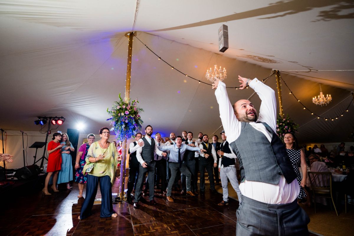 Groom throws a bottle of whiskey, the catcher gets to keep it. at The Mount Ephraim Gardens