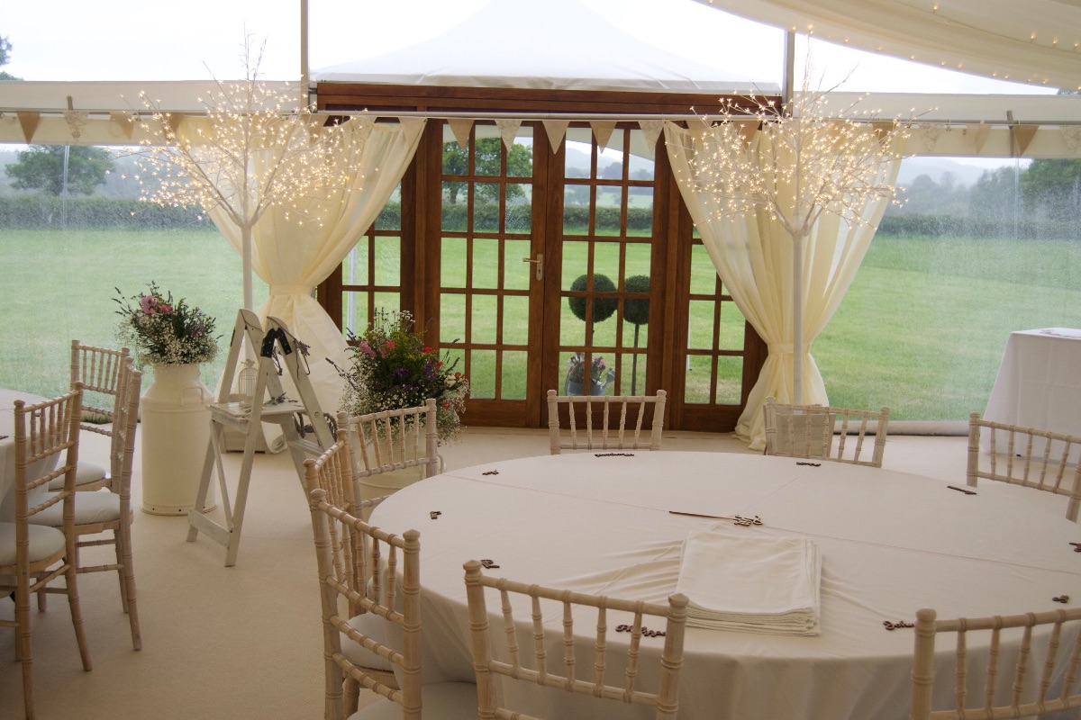Lit blossom trees framing the marquee entrance