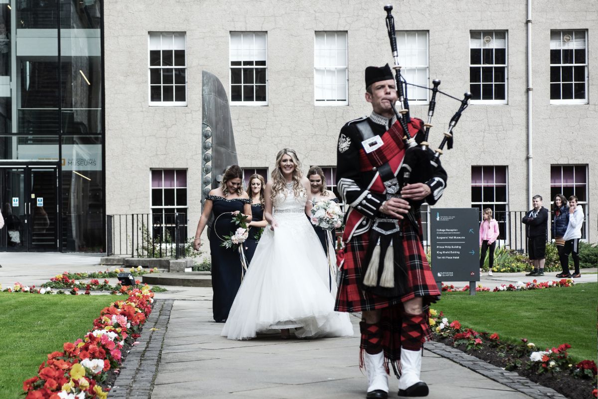 Stacy is piped through the College Gardens to the Playfair Building for her ceremony.