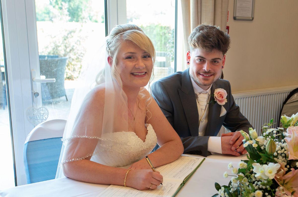 Andrew and Sophie signing the register