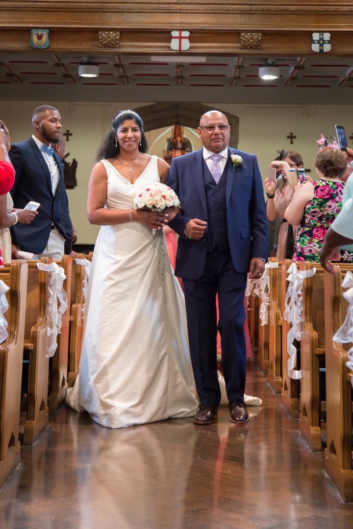 Angela and her father walking down the aisle
