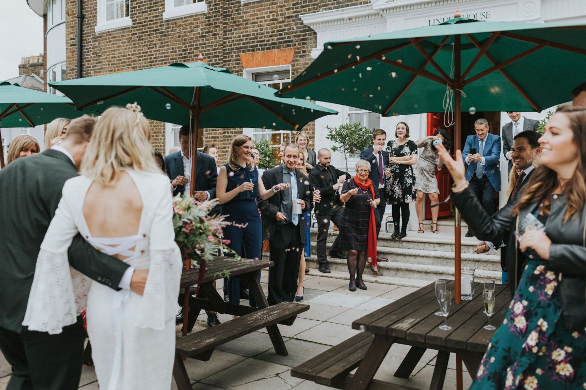 The beautiful couple arriving to their friends on the terrace. 