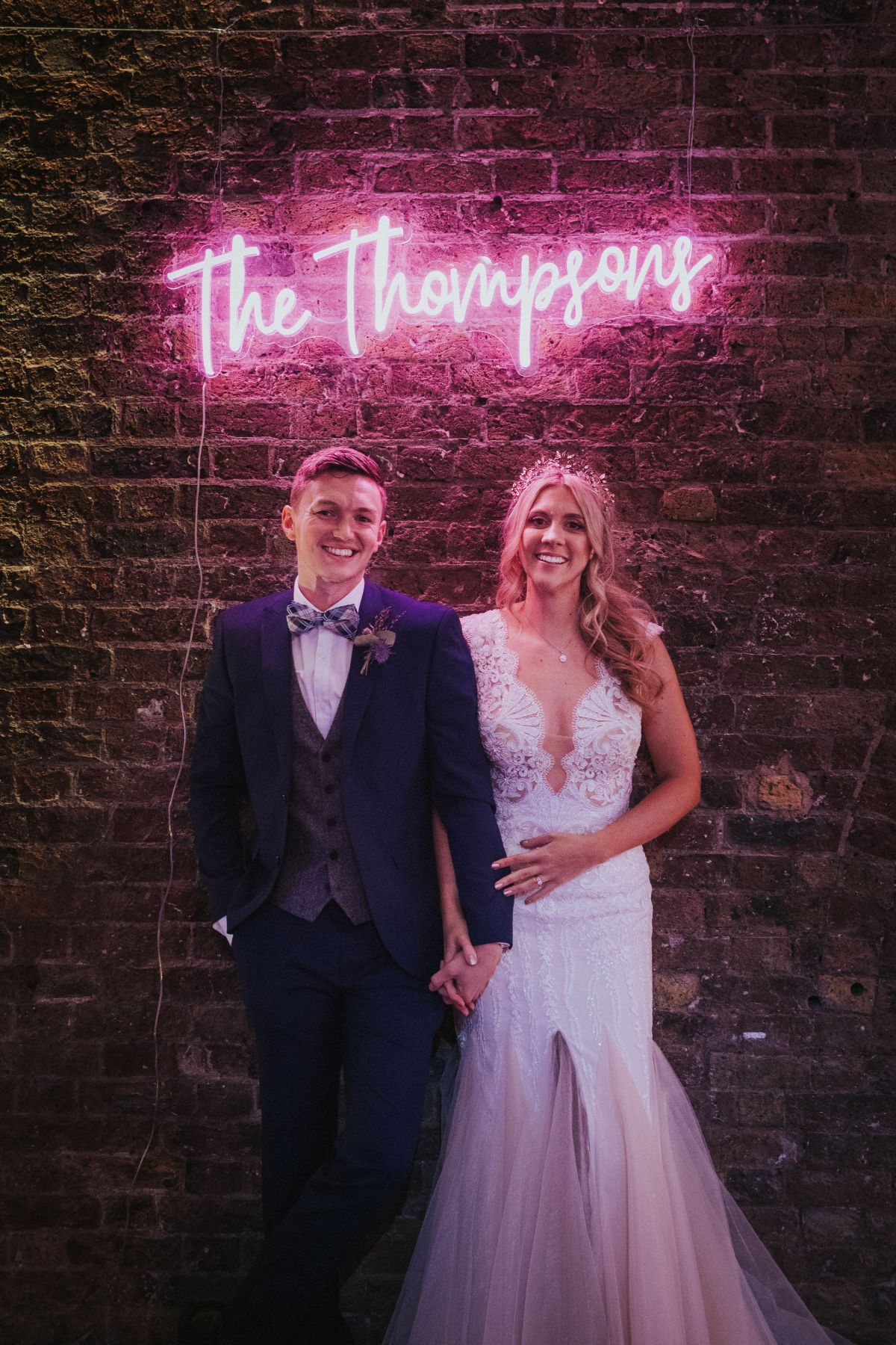 Couple shot with custom neon light and Shoreditch Studios exposed brick walls. 