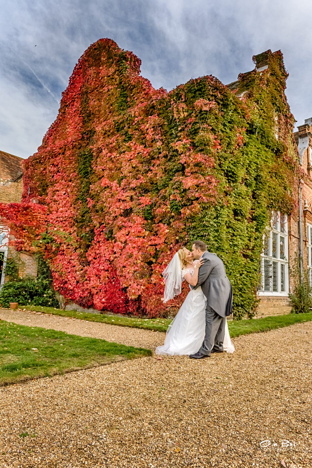 Stealing a kiss in front of the Manor, adorned with its glorious, orange and red autumn colours.