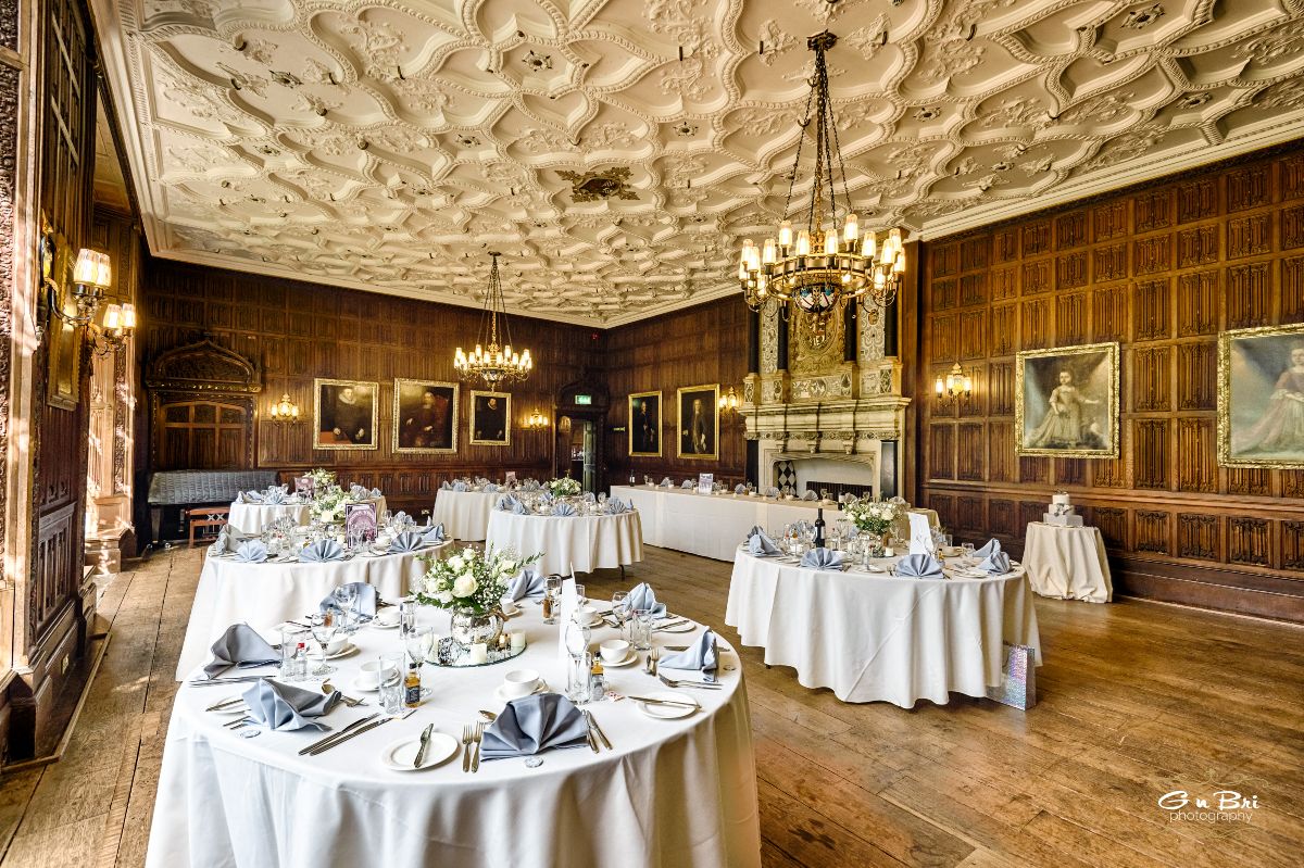 The Great Drawing Room at Rothamsted Manor laid for the wedding breakfast of Andrew and Zuzana, with beautiful warm blue tones