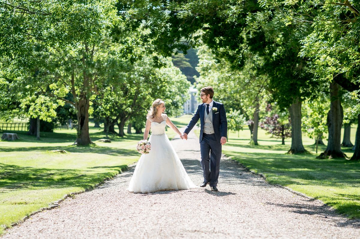 Lydia & Simon stroll hand in hand along with sweeping driveway at Folkington