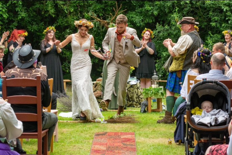 Our ceremony ended with the traditional jumping of the broom (into our new lives together)