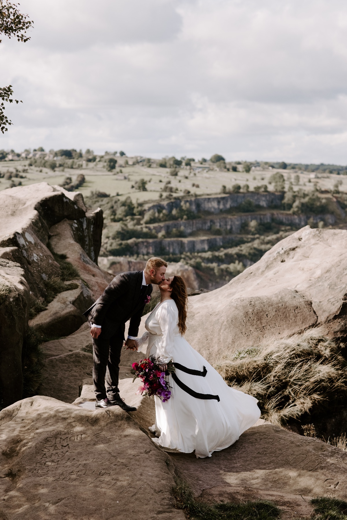 Chloe's stunning bespoke dress paired with vans for a quick climb up black rocks. 