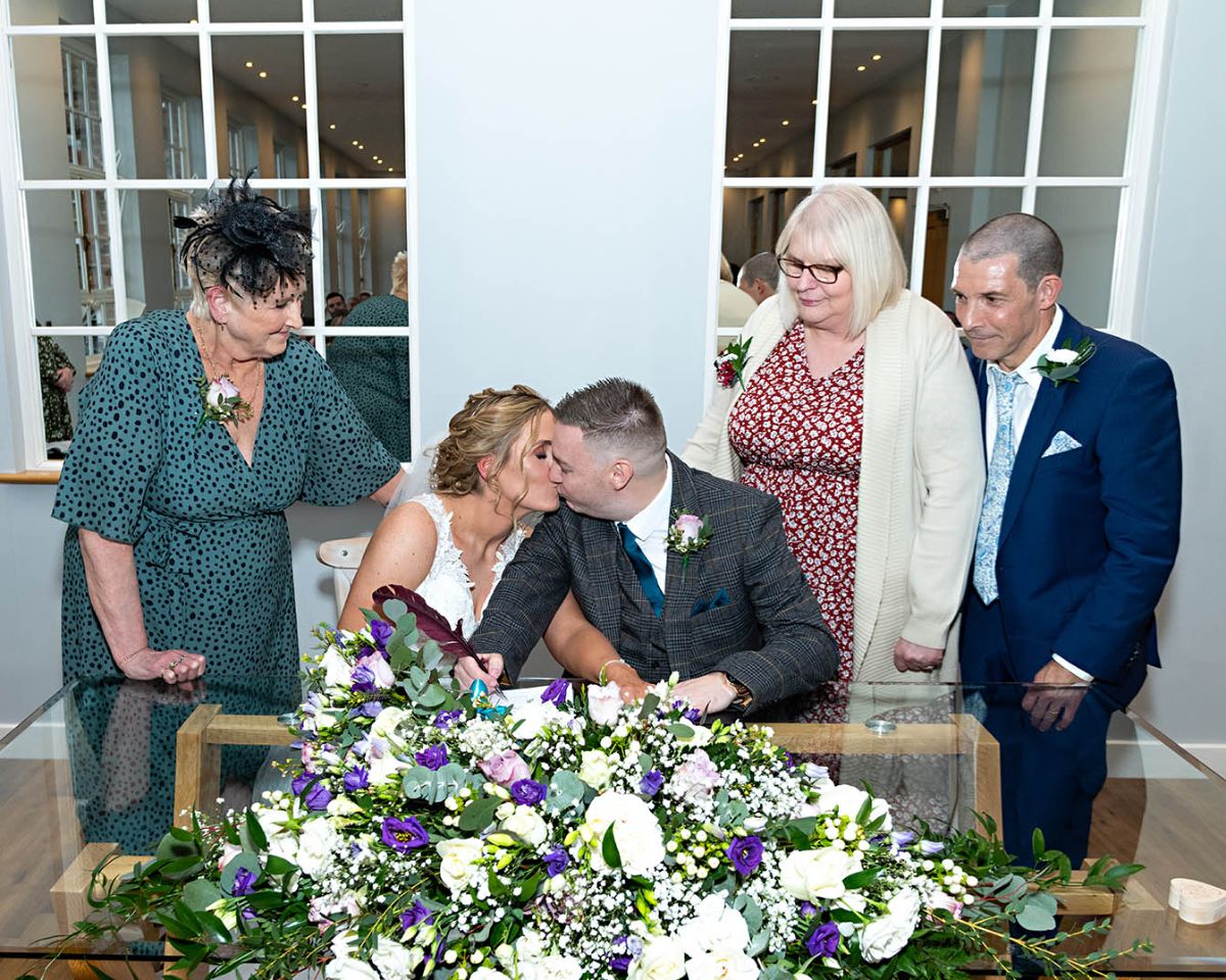 The first kiss in front of proud mums and dads