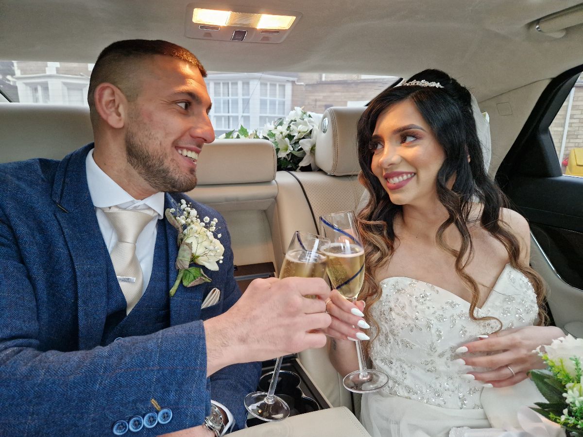 A champagne toast for the drive to their reception venue.