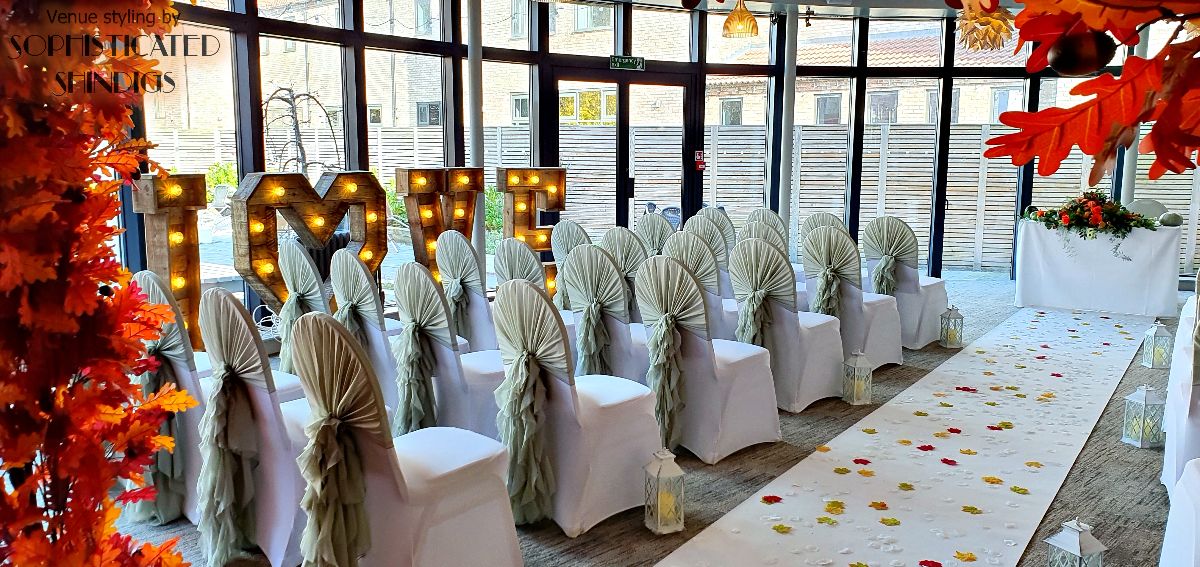 View down the aisle, showing our chair dressing, aisle dressing, and rustic LOVE letters.