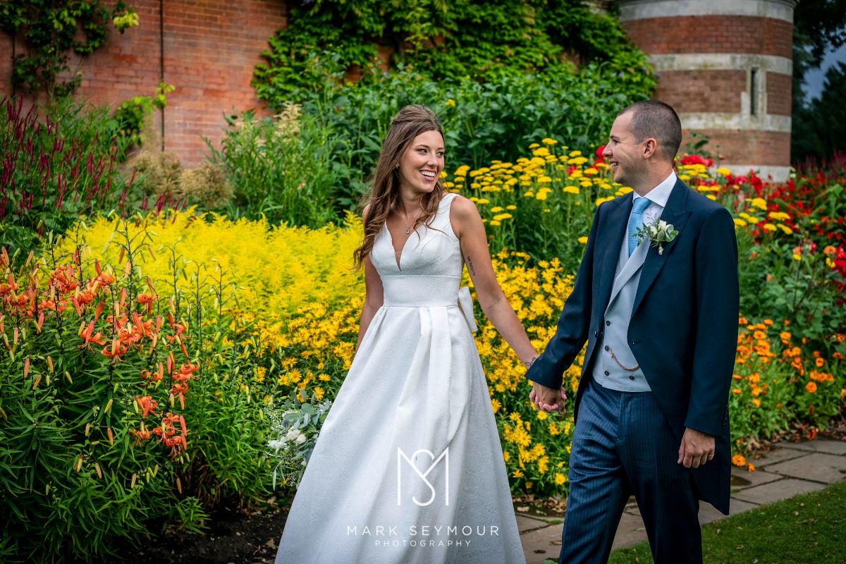 Bride and groom strolling at Cliveden