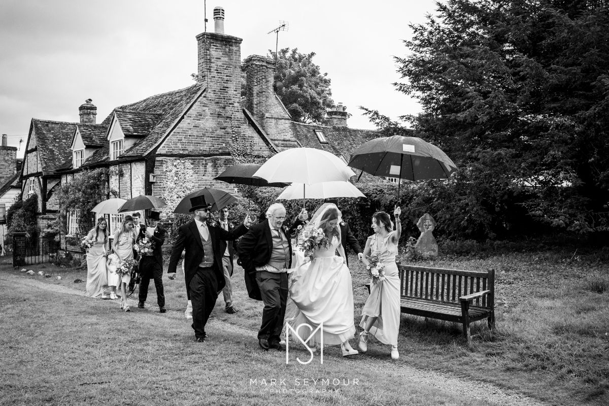 Bride arriving at church in Rain